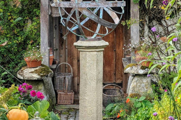 Bronze-Armillary-50cm-in-a-cottage-garden-setting-on-an-extra-tall-Cupola-plinth-scaled-600x400 Bronze