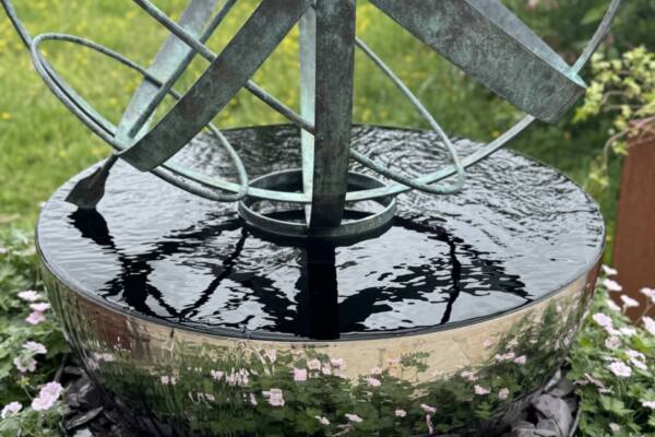 Reflections-of-a-bronze-armillary-sphere-scaled-600x400 Cascade