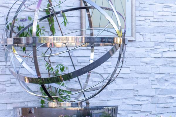 Stainless-steel-armillary-sphere-raised-up-on-a-planter-600x400 Cascade